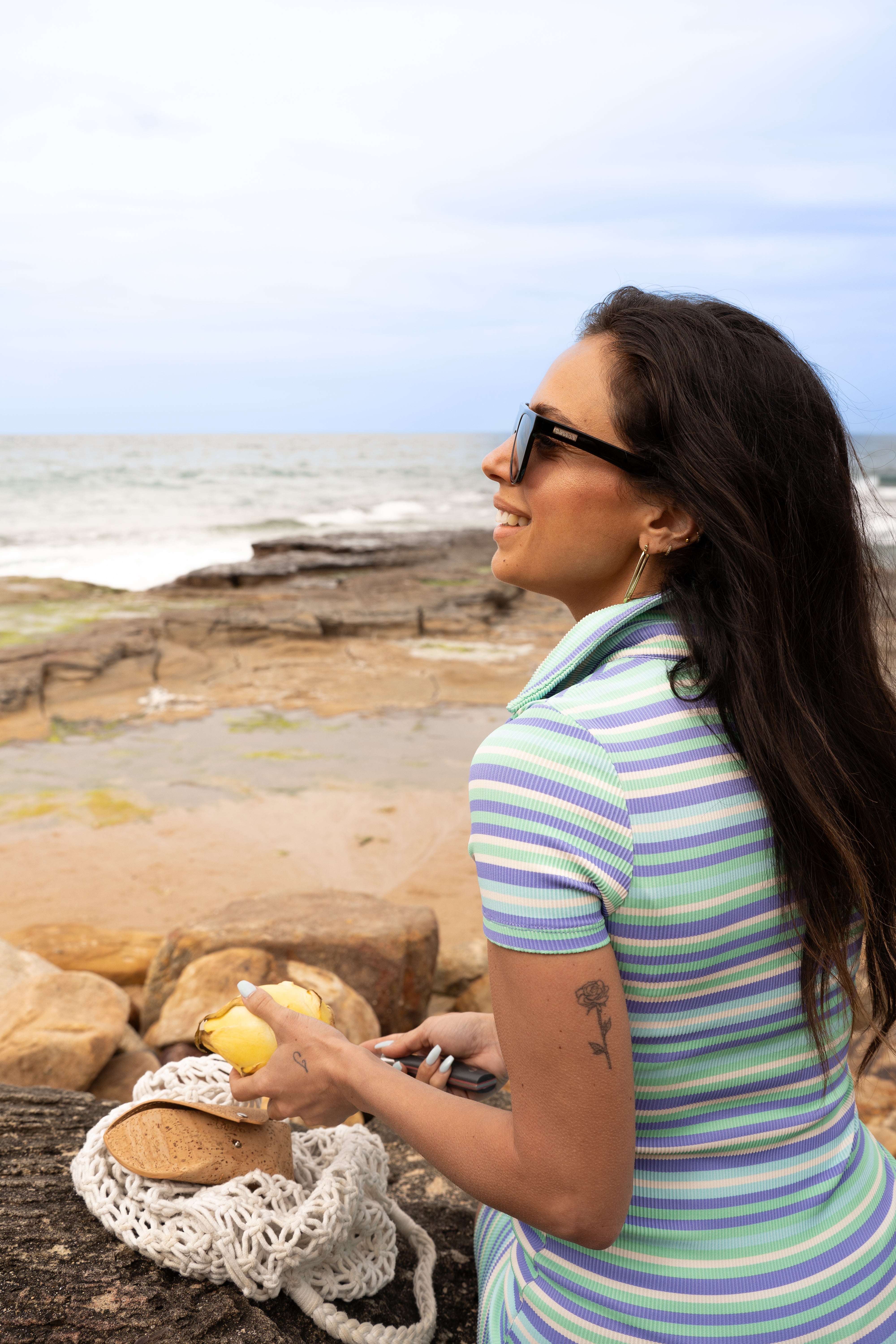 Orca Black sunglasses model on beach