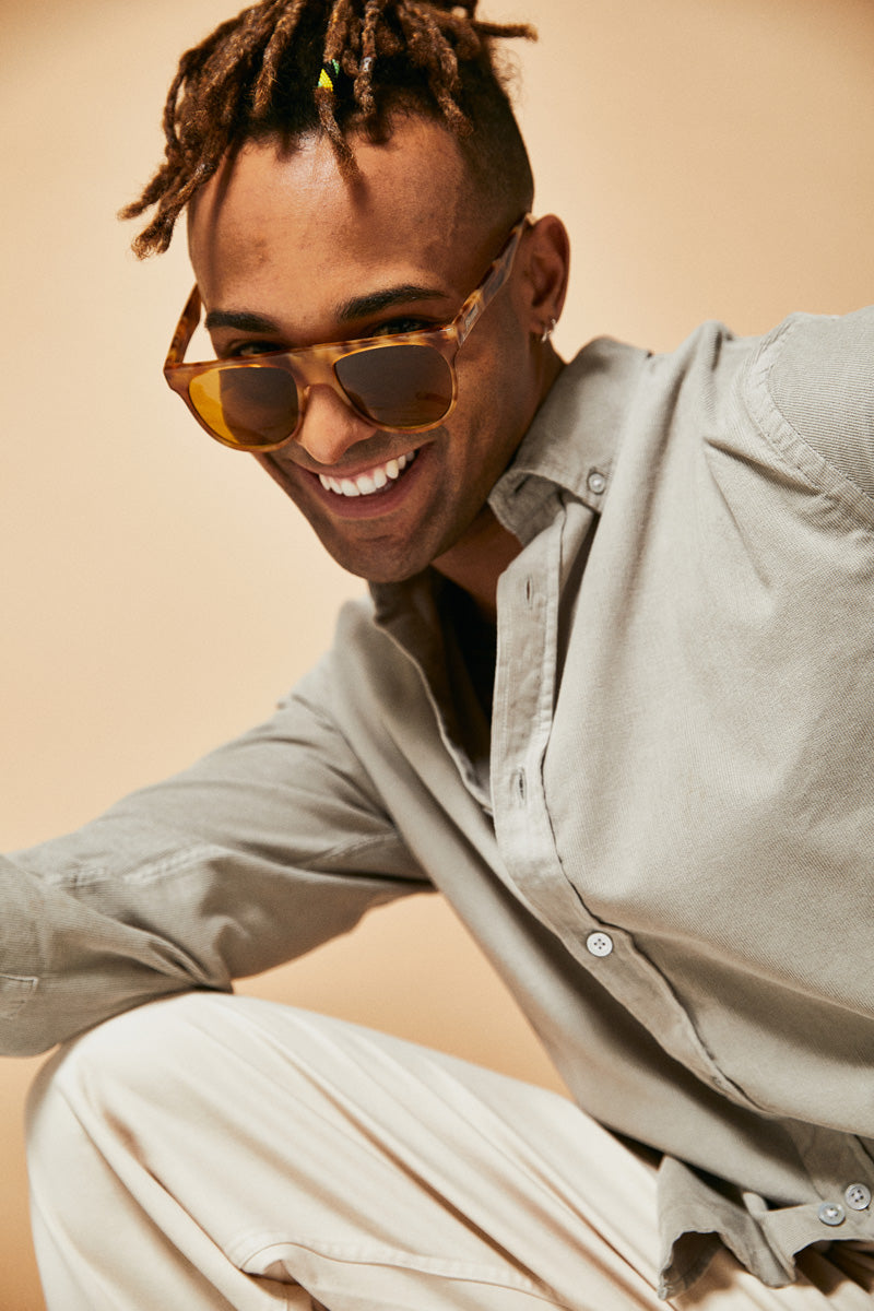 Male model wearing orange prescription sunglasses from Ozeano Vision