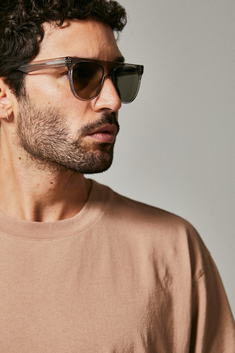 Male model wearing grey prescription sunglasses from Ozeano Vision