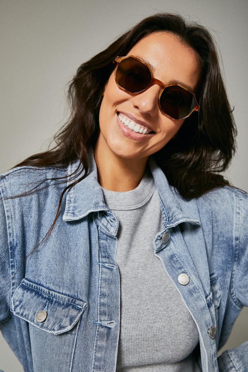 Female model wearing orange polarised sunglasses from Ozeano Vision