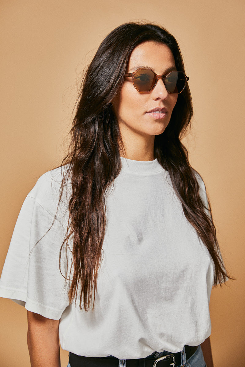 Female model wearing brown prescription sunglasses from Ozeano Vision