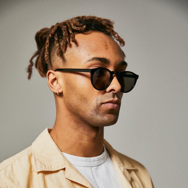 Male model wearing black orca Sunglasses sunglasses