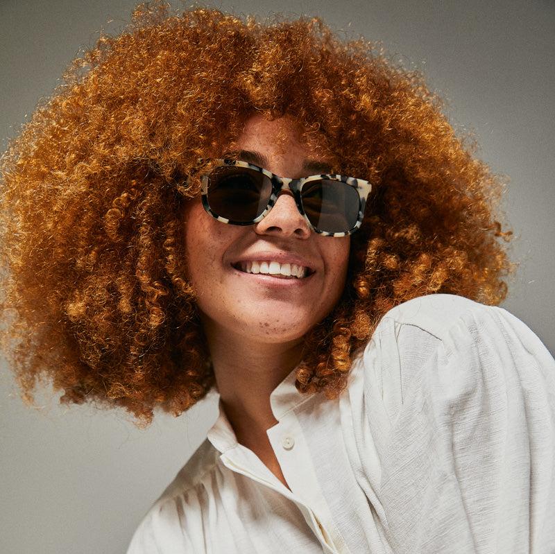 Female model wearing black and white leopardseal sunglasses from Ozeano Vision