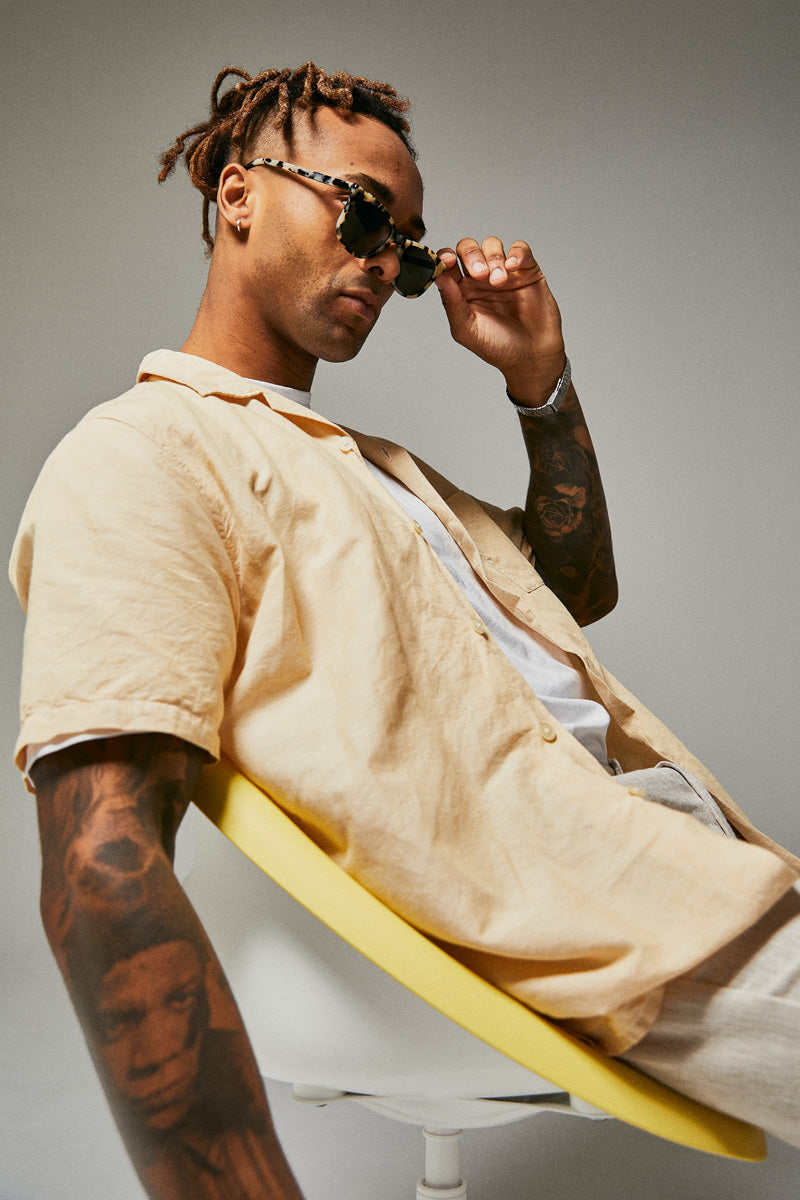 Male model wearing black and white prescription sunglasses from Ozeano Vision