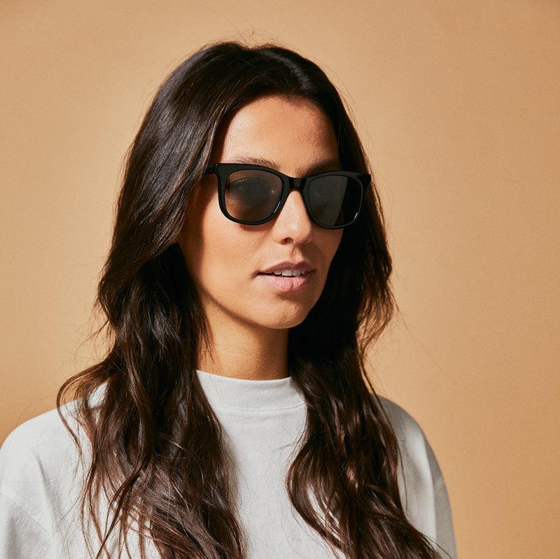 Stylish Female model wearing black polarised sunglasses from Ozeano Vision