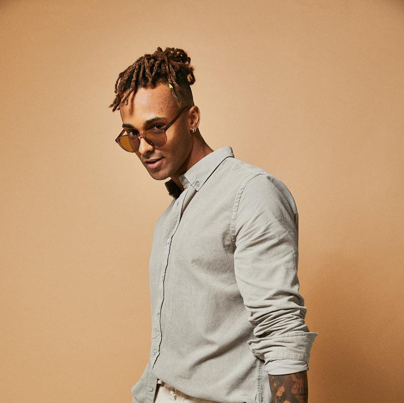 Male model wearing brown polarised sunglasses