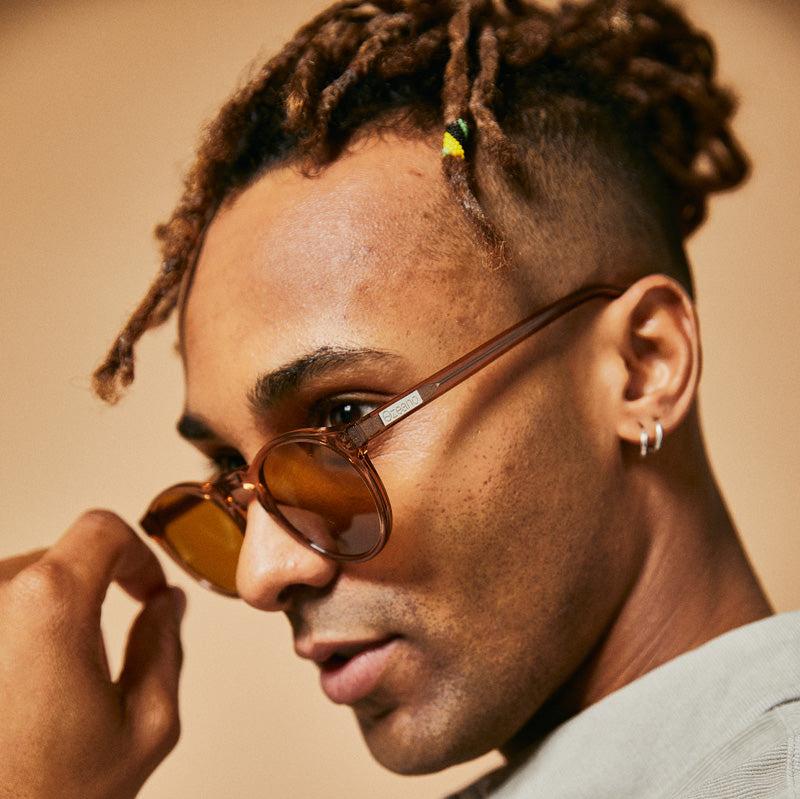 Male model wearing sleek brown polarised sunglasses