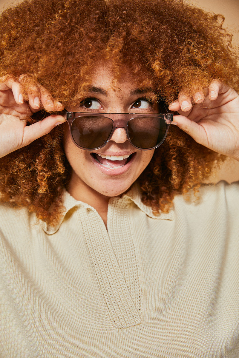 Female model wearing grey polarised sunglasses from Ozeano Vision