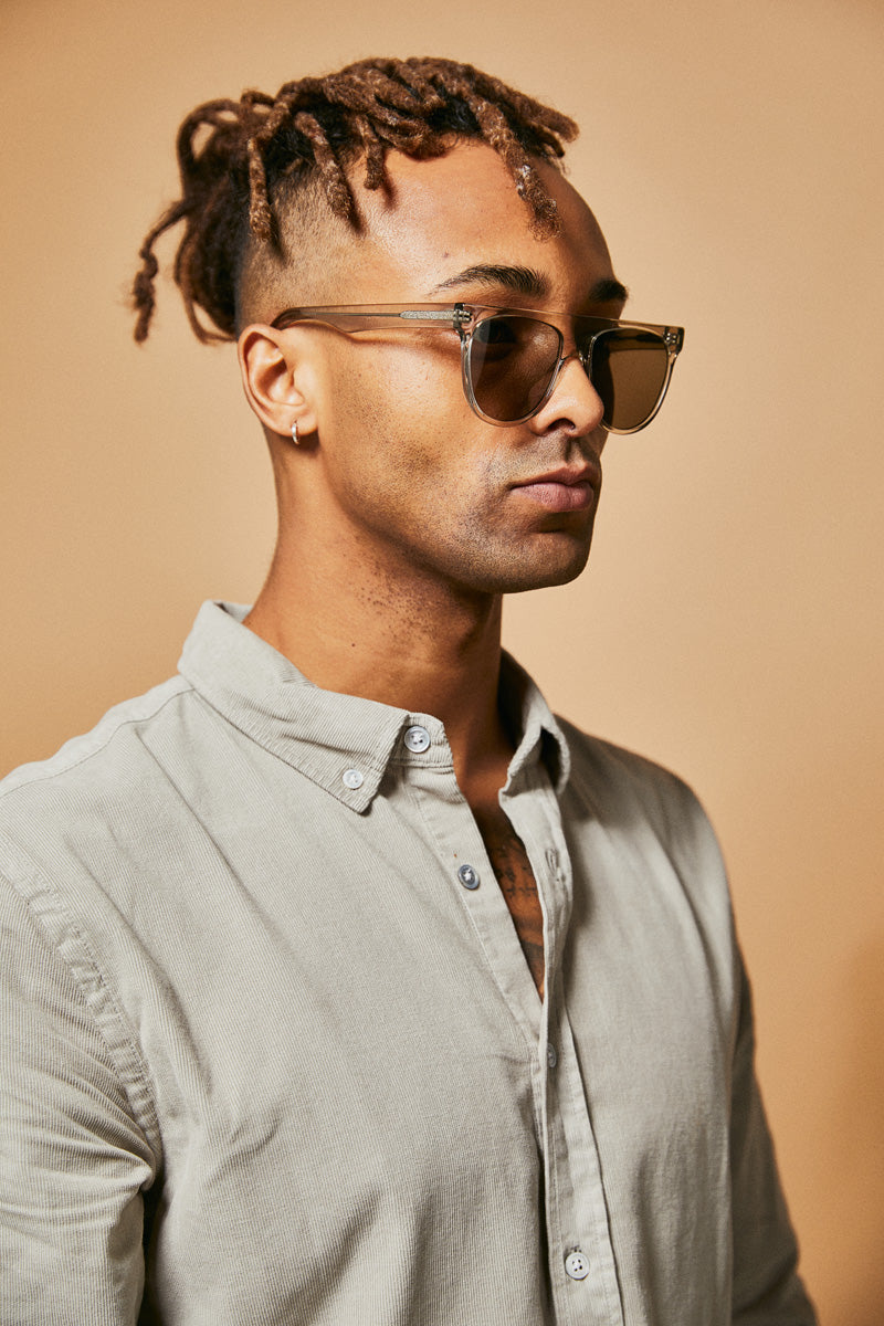 Male model wearing green prescription sunglasses from Ozeano Vision