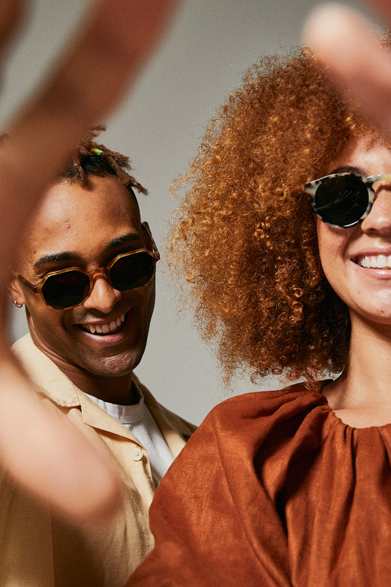 Male model wearing orange polarised sunglasses from Ozeano Vision