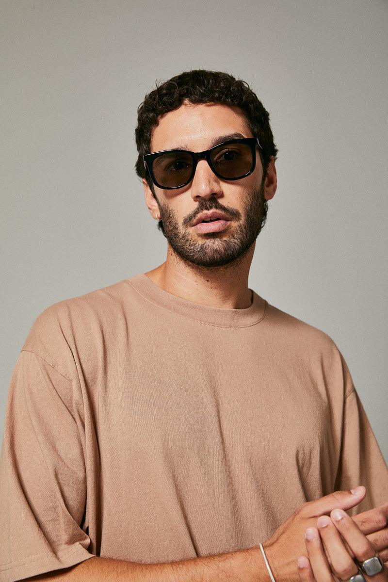 Male model wearing black prescription sunglasses from Ozeano Vision