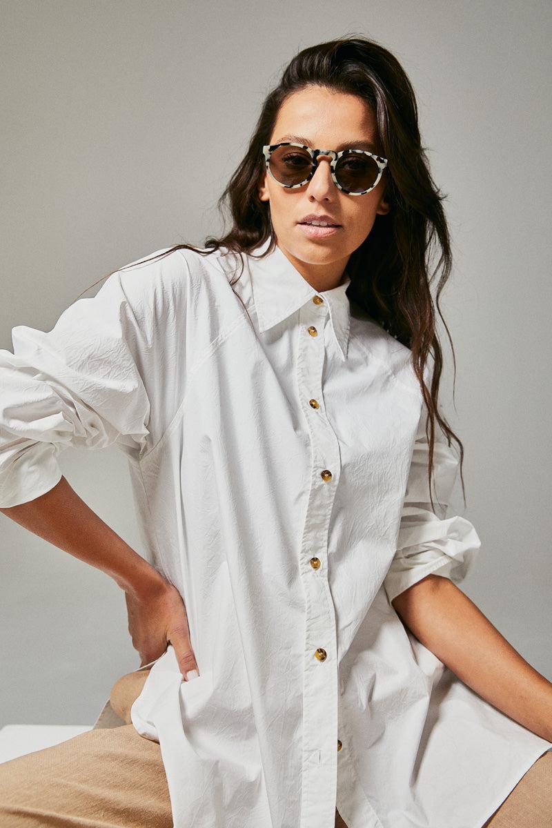 Female model wearing black and white polarised sunglasses