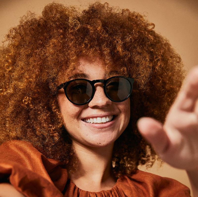 Female model wearing black orca polarised sunglasses