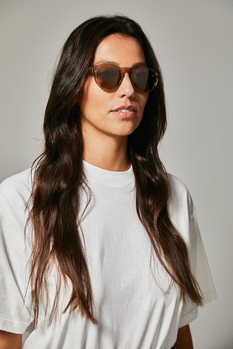 Female model wearing brown prescription sunglasses